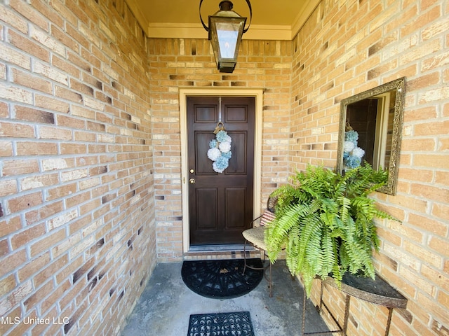 entrance to property with brick siding