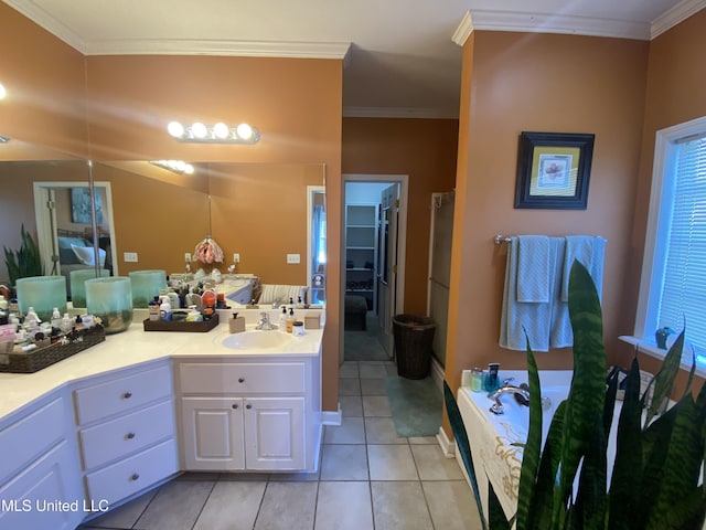 full bathroom with tile patterned floors, vanity, a bath, and crown molding