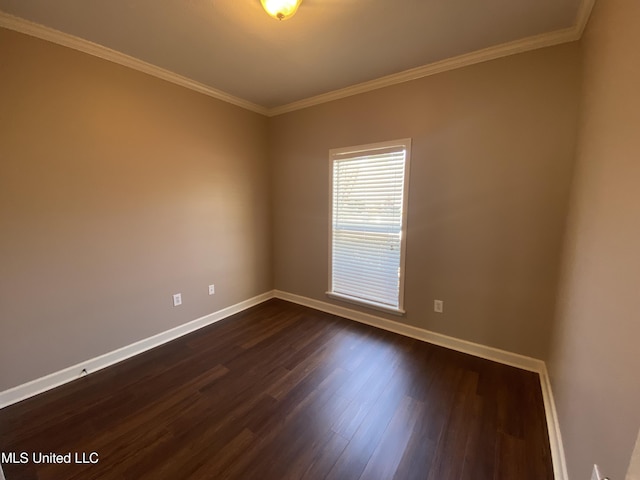 empty room featuring baseboards, dark wood-style flooring, and crown molding