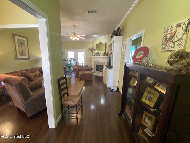 hall with visible vents, baseboards, dark wood-style floors, and crown molding