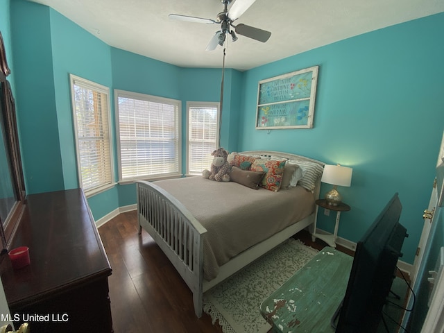 bedroom with a ceiling fan, dark wood-style floors, and baseboards