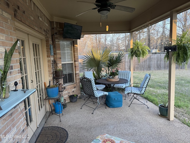 view of patio with ceiling fan and fence