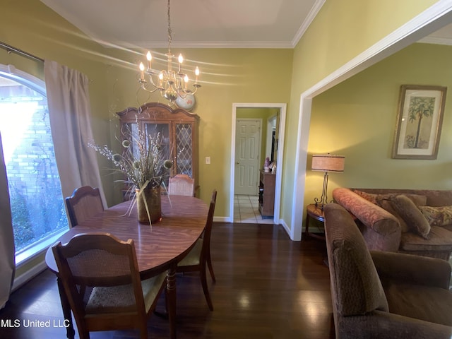 dining room with a notable chandelier, wood finished floors, baseboards, and ornamental molding