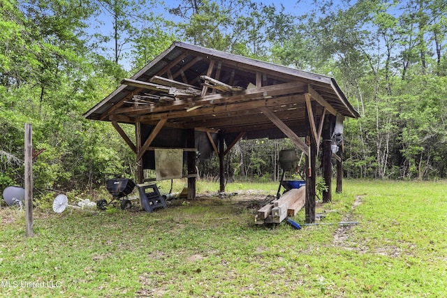 view of community with a detached carport and a lawn