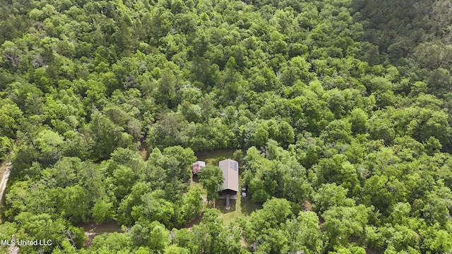 birds eye view of property featuring a wooded view