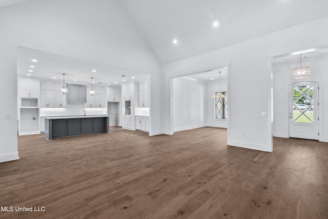 308 Lois Ct, Madison, MS 39110 - unfurnished living room featuring a chandelier, recessed lighting, a sink, dark wood-type flooring, and vaulted ceiling
