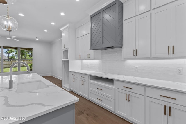 308 Lois Ct, Madison, MS 39110 - kitchen with a sink, dark wood finished floors, recessed lighting, white cabinets, and tasteful backsplash