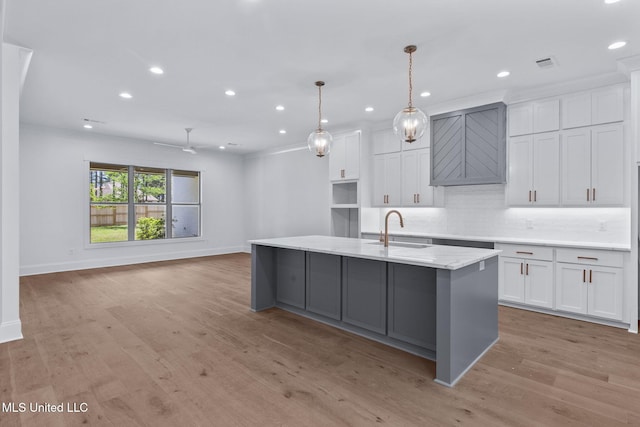 308 Lois Ct, Madison, MS 39110 - kitchen with a sink, white cabinets, recessed lighting, a center island with sink, and baseboards