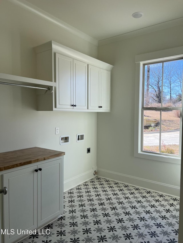 laundry area featuring hookup for an electric dryer, a wealth of natural light, washer hookup, cabinets, and ornamental molding