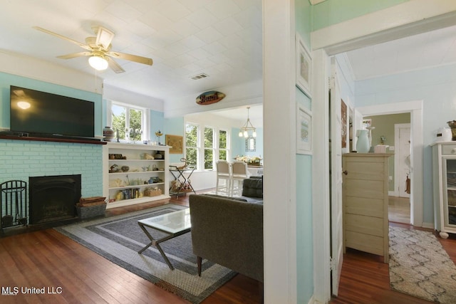 828 Woodward Ave, Gulfport, MS 39501 - living area featuring a brick fireplace, wood finished floors, and a ceiling fan