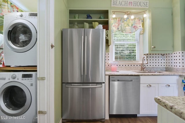 828 Woodward Ave, Gulfport, MS 39501 - washroom featuring stacked washer / dryer and a sink