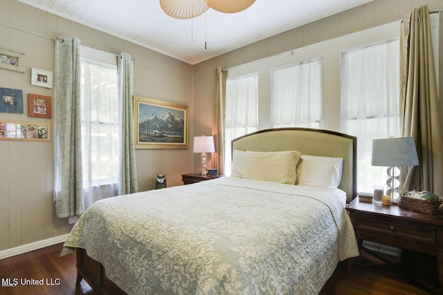 bedroom with ceiling fan, dark hardwood / wood-style flooring, and ornamental molding