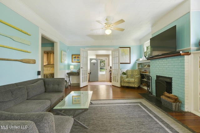 living room with a fireplace, french doors, dark hardwood / wood-style floors, and plenty of natural light