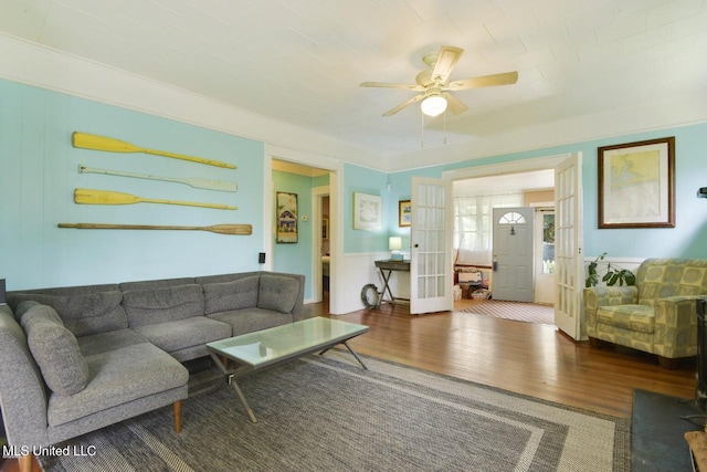 living room featuring wood-type flooring, french doors, and ceiling fan