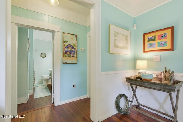 hall featuring dark hardwood / wood-style flooring and ornamental molding