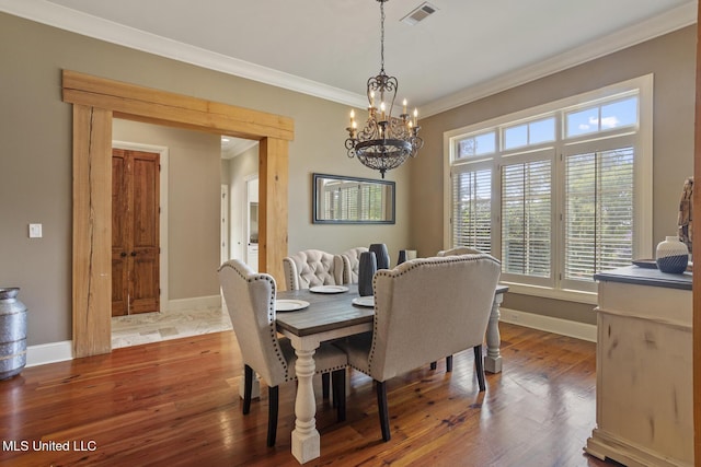 430 Johnstone Dr, Madison, MS 39110 - dining space featuring crown molding, a chandelier, baseboards, and wood finished floors