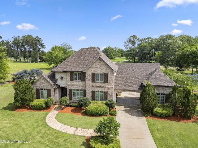 430 Johnstone Dr, Madison, MS 39110 - french country inspired facade featuring concrete driveway, roof with shingles, brick siding, and a front yard