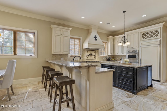 430 Johnstone Dr, Madison, MS 39110 - kitchen featuring premium range hood, dark cabinets, a peninsula, backsplash, and ornamental molding