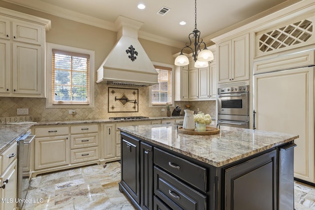 430 Johnstone Dr, Madison, MS 39110 - kitchen with appliances with stainless steel finishes, custom exhaust hood, cream cabinets, dark cabinets, and recessed lighting