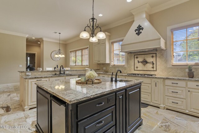 430 Johnstone Dr, Madison, MS 39110 - kitchen with a sink, custom range hood, an island with sink, a chandelier, and crown molding