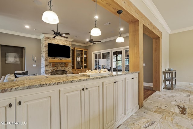 430 Johnstone Dr, Madison, MS 39110 - kitchen featuring a fireplace, ceiling fan, crown molding, baseboards, and light stone countertops