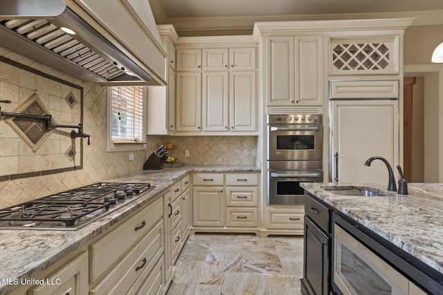 430 Johnstone Dr, Madison, MS 39110 - kitchen with custom exhaust hood, stainless steel appliances, a sink, cream cabinets, and light stone countertops