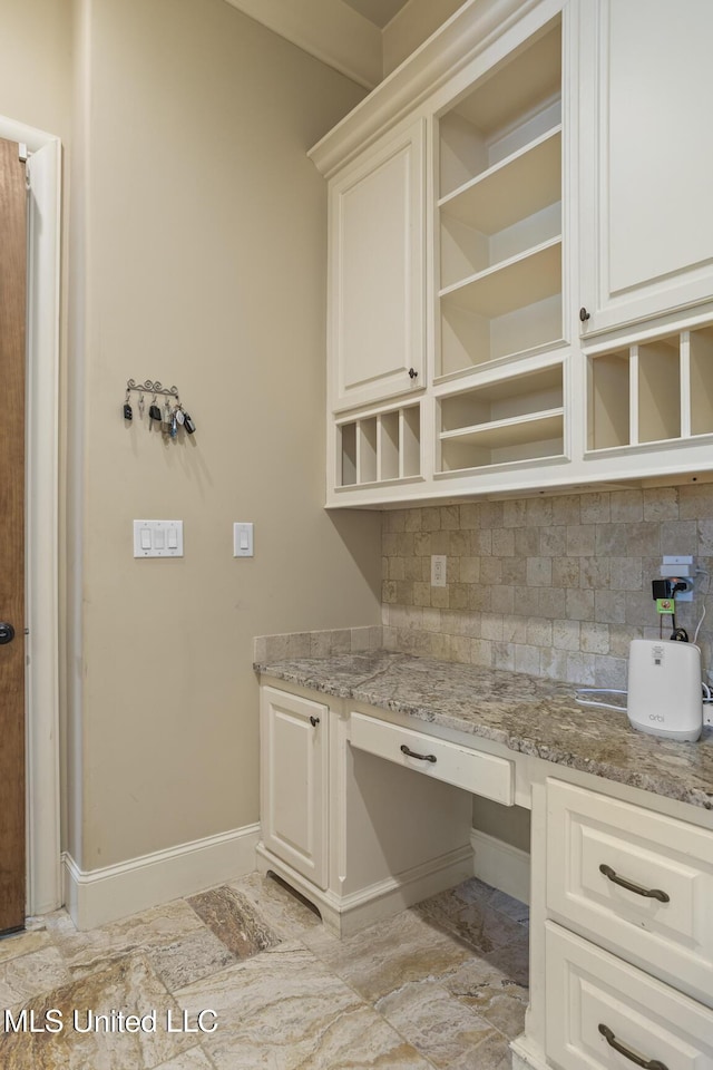 430 Johnstone Dr, Madison, MS 39110 - kitchen with open shelves, baseboards, decorative backsplash, and light stone countertops