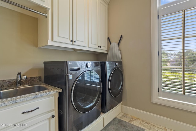 430 Johnstone Dr, Madison, MS 39110 - laundry room featuring cabinet space, healthy amount of natural light, and separate washer and dryer