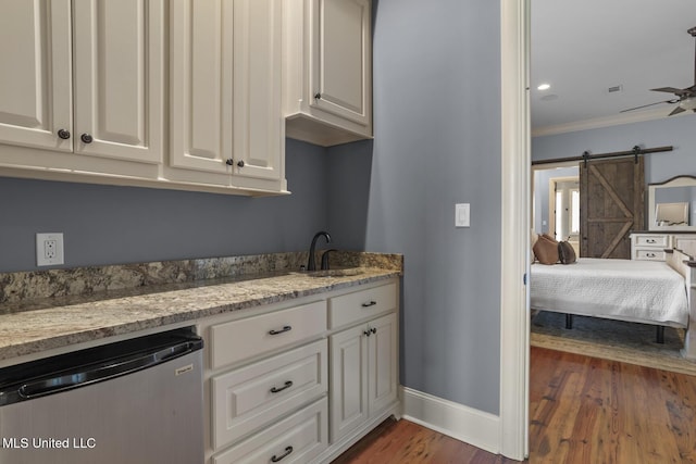 430 Johnstone Dr, Madison, MS 39110 - washroom with baseboards, ornamental molding, dark wood-style flooring, a sink, and a barn door