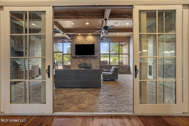 430 Johnstone Dr, Madison, MS 39110 - living room with wooden ceiling with exposed beams, wood finished floors, a ceiling fan, a fireplace, and plenty of natural light