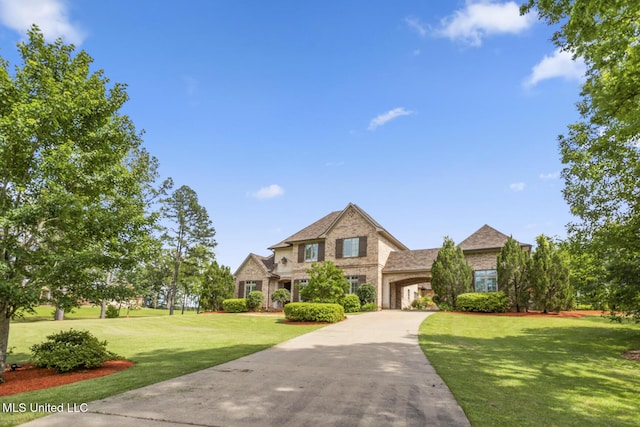 430 Johnstone Dr, Madison, MS 39110 - traditional-style home featuring a front yard, driveway, brick siding, stone siding, and an attached garage