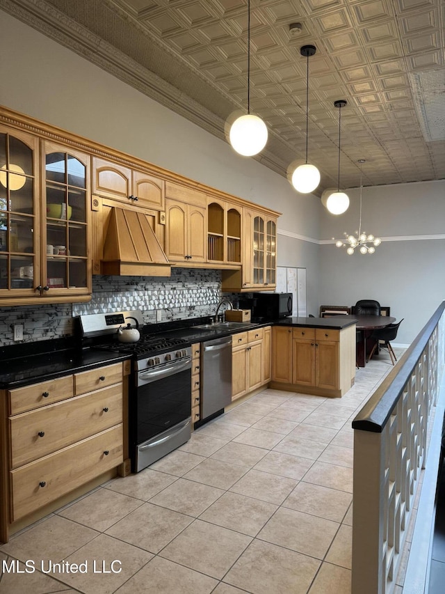 kitchen featuring pendant lighting, custom exhaust hood, light tile patterned floors, and appliances with stainless steel finishes