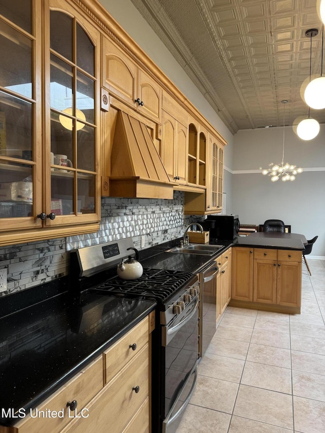 kitchen featuring sink, stainless steel appliances, backsplash, decorative light fixtures, and light tile patterned floors