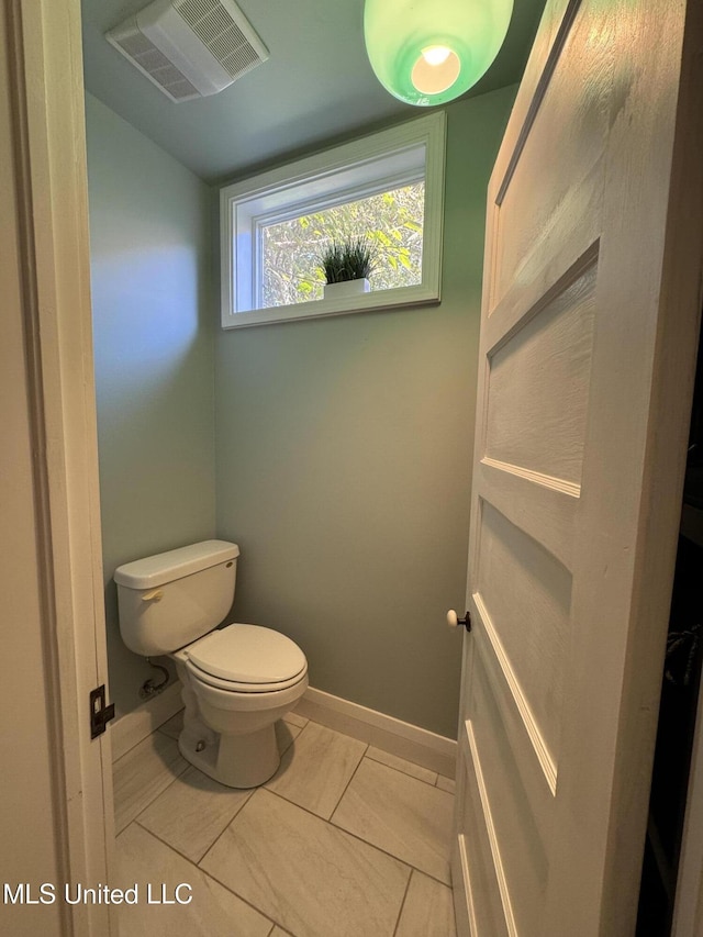 bathroom featuring tile patterned flooring and toilet