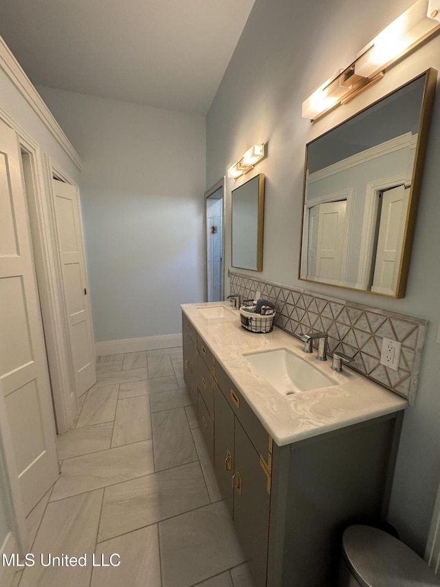 bathroom with vanity and decorative backsplash