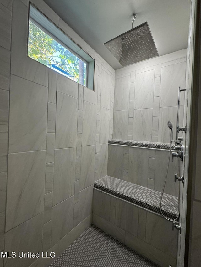 bathroom with a tile shower