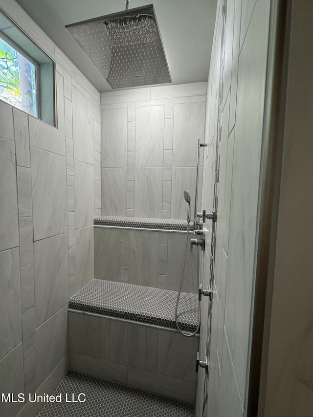 bathroom with tiled shower