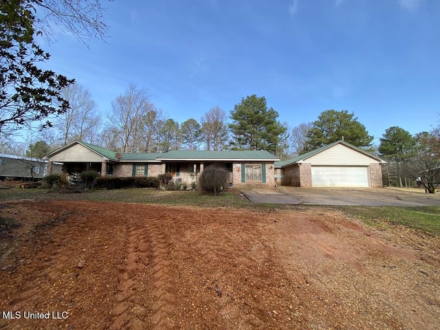 ranch-style home with an attached garage, concrete driveway, and brick siding