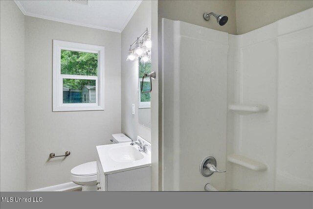 bathroom with vanity, crown molding, toilet, and a shower