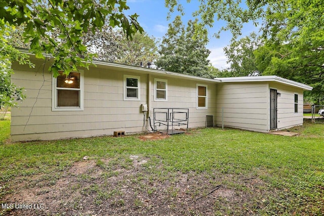 rear view of house with a lawn