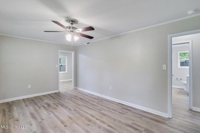 spare room with ornamental molding, light hardwood / wood-style flooring, and ceiling fan