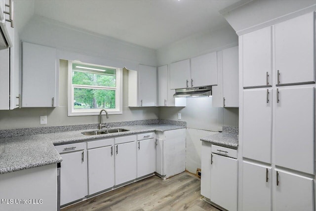 kitchen with light hardwood / wood-style floors, white cabinets, and sink