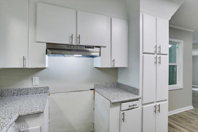 kitchen with white cabinetry, light hardwood / wood-style floors, and ventilation hood