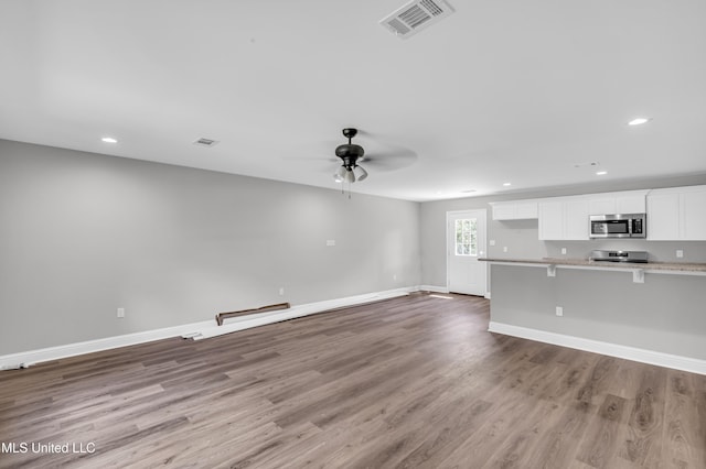133 Maria St, Poplarville, MS 39470 - unfurnished living room featuring ceiling fan, wood finished floors, recessed lighting, and baseboards