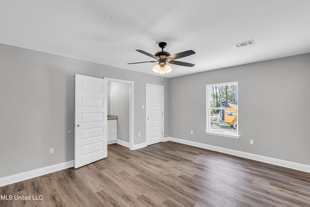 133 Maria St, Poplarville, MS 39470 - unfurnished bedroom featuring wood finished floors, baseboards, and ceiling fan