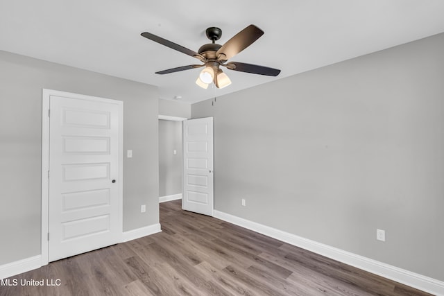 133 Maria St, Poplarville, MS 39470 - unfurnished bedroom with wood finished floors, baseboards, and ceiling fan