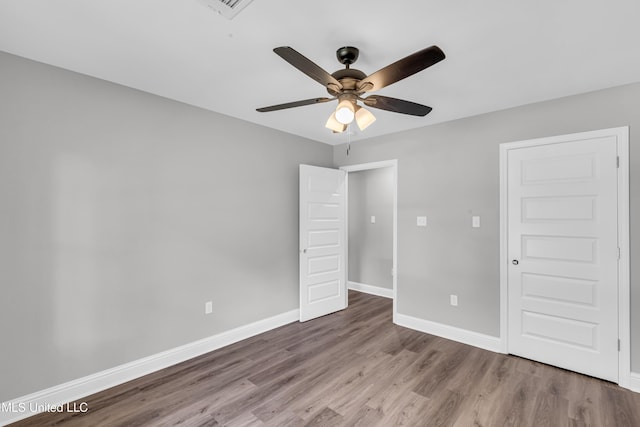 133 Maria St, Poplarville, MS 39470 - unfurnished bedroom with wood finished floors, baseboards, and ceiling fan