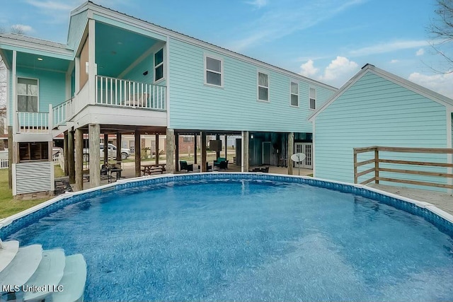 pool with stairway and a patio