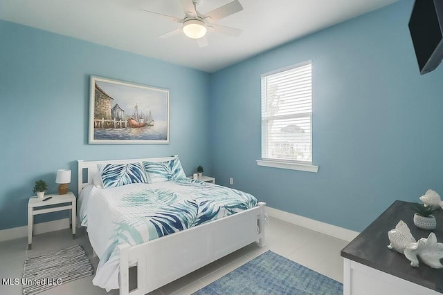 tiled bedroom featuring ceiling fan and baseboards