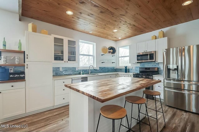 kitchen featuring wooden ceiling, stainless steel appliances, a sink, wooden counters, and open shelves